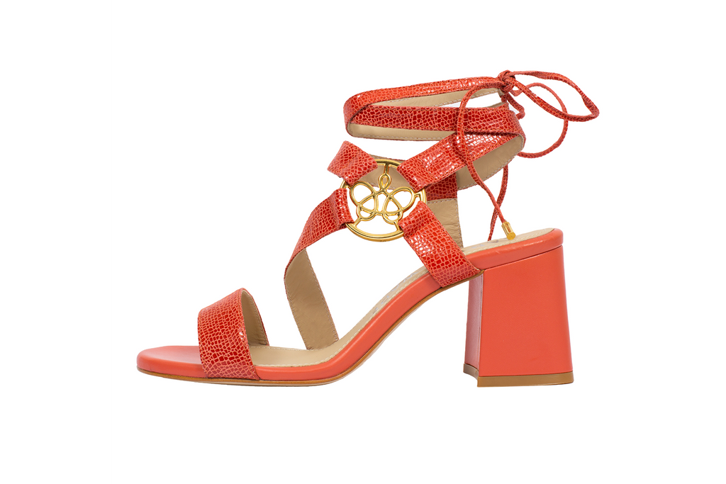 Lara coral embossed leather ankle-tie sandal with asymmetric straps and gold logo ornament, set on 65mm flared block heel